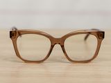 glasses on a wooden table with a white wall in the background