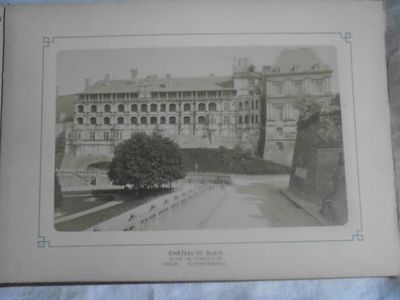 an old picture of a large building with a clock on it