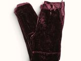 the leggings of a pair of velvet pants on a white surface