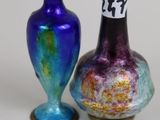 two vases sitting next to each other on a table