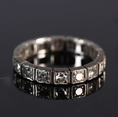 a close up of a diamond ring on a black surface