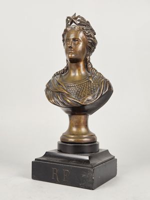 a bronze bust of a woman on a marble base