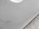 a close up of a car door with a hole in it