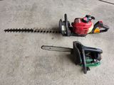 two chainsaws sitting on the ground next to each other