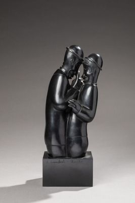 a black sculpture of a man and a woman hugging each other