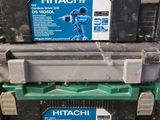 two boxes of hitachi tools sitting on top of each other