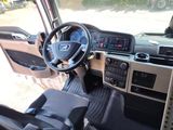 a view of the inside of a bus with a steering wheel and dashboard
