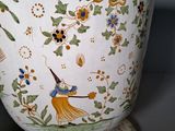 a vase with a design on it sitting on a table