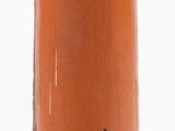 an orange vase with a black and white logo on it