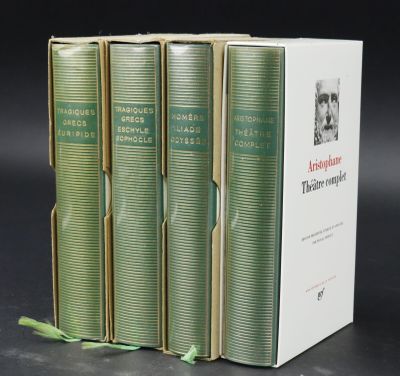 three books are stacked on top of each other on a table