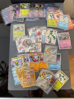 a lot of pokemon cards on top of a table