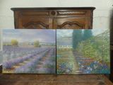 deux tableaux représentant des champs de lavande, posés sur une table en bois devant une commode