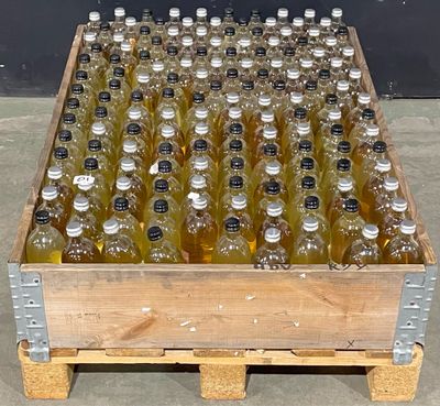 a wooden crate filled with lots of bottles of alcohol