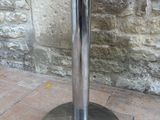 an image of a black and silver table on a brick floor