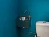 a toilet and a sink in a bathroom with a blue wall