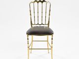a gold and black chair with a leather seat
