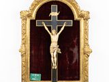 a gold framed crucifix with a cross on it