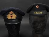 two hats with a crown on top of them sitting next to each other