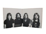 an old black and white photo of a group of men with long hair