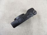 a black camera sitting on a white surface