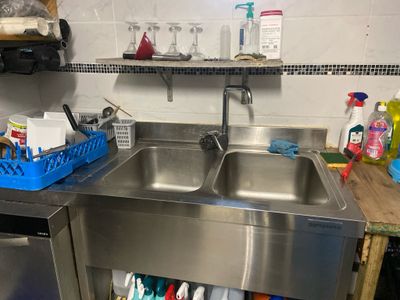 a stainless steel sink and a dishwasher in a kitchen