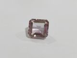 a pink tourmaline gems stone on a white surface
