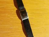 a watch that is sitting on a wooden table
