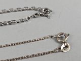 a silver chain that has a heart on it