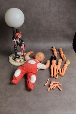 a small doll and a lamp on a table