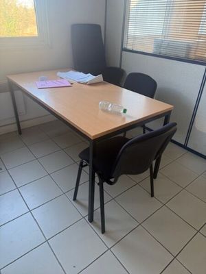 a table and chairs in a room with a window