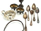 a lot of silver spoons and silverware on the table