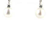 a pair of pearl and diamond earrings on a white background