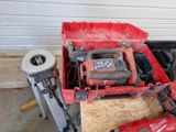 a red box with tools in it sitting on the floor