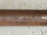 an old wooden pipe with a label on it sitting on a table