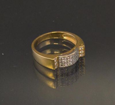 an image of a gold and diamond ring on a black surface