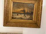 two framed pictures hanging on the wall above a mirror