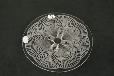 a glass plate with a white doily on it