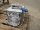 a fan that is sitting on a pallet on the ground