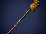 an old wooden stick with a flower on it against a blue background