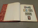 an open book with stamps on it sitting on a table