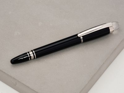a pen that is laying on top of a book
