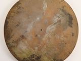 a large round metal object on a white surface