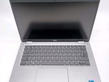 an open laptop computer sitting on top of a white table