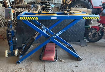 a blue scissor sitting on top of a table in a garage