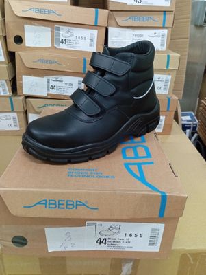 a pair of black shoes on top of a cardboard box