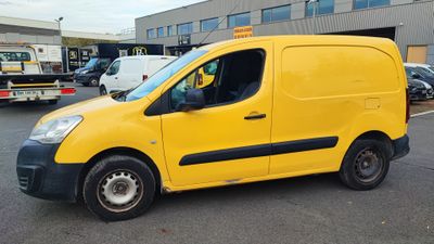 yellow van parked in a parking lot with other vehicles in the background
