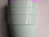 purple and green cups stacked on top of each other on a counter