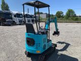 the back end of a blue mini excavator parked in a parking lot