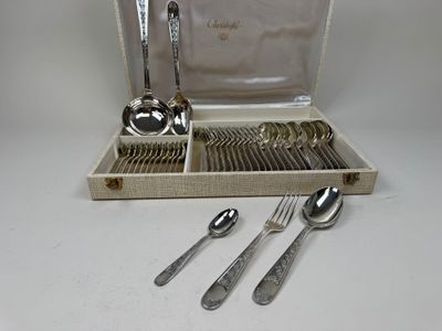 a silverware set in a case with spoons and spoons