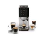 un gros plan d'une machine à café avec deux tasses de café devant